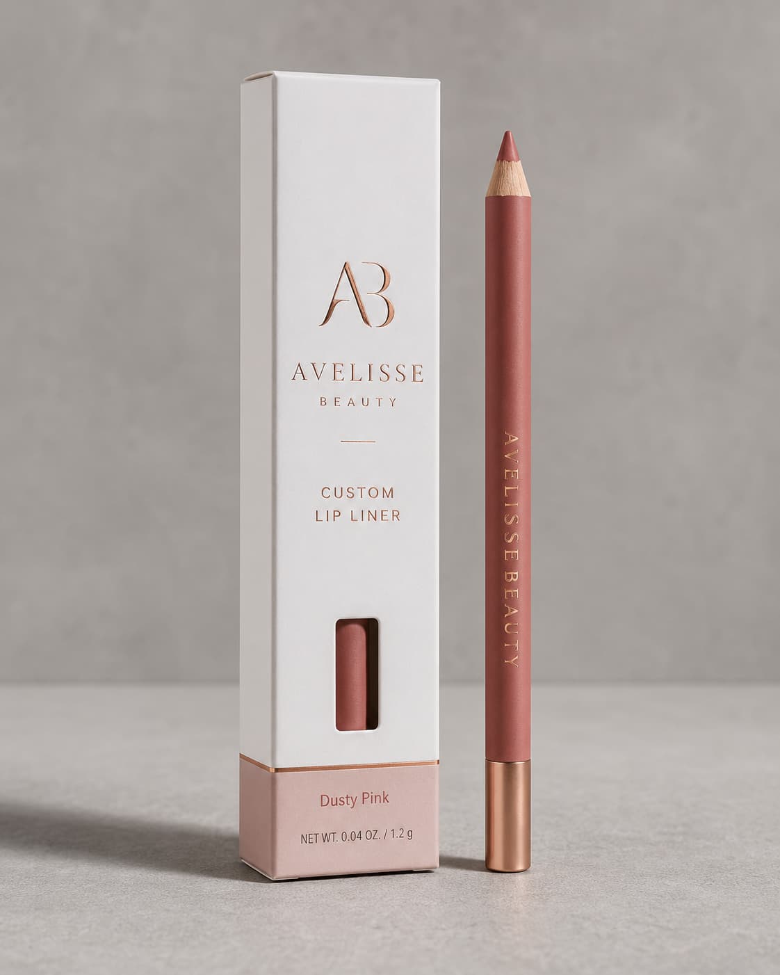 White custom lip liner box with rose gold logo, window cutout, and matching pencil.