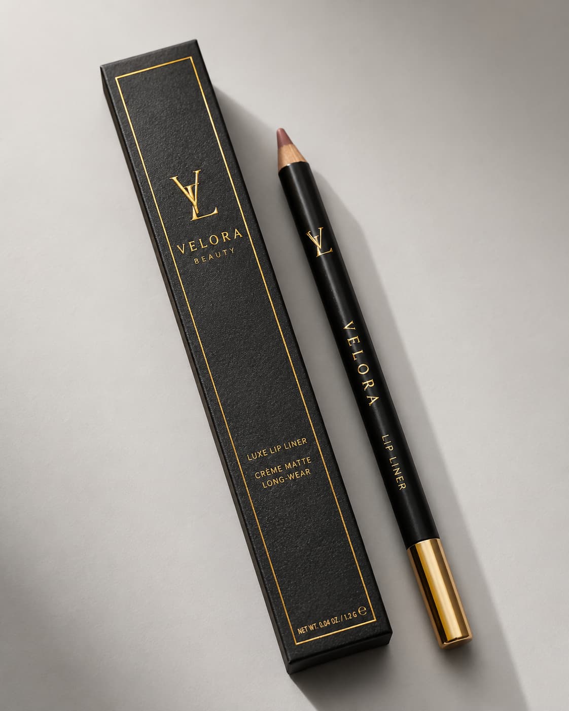 Black luxury lip liner packaging with gold foil logo and matching black lip liner pencil.