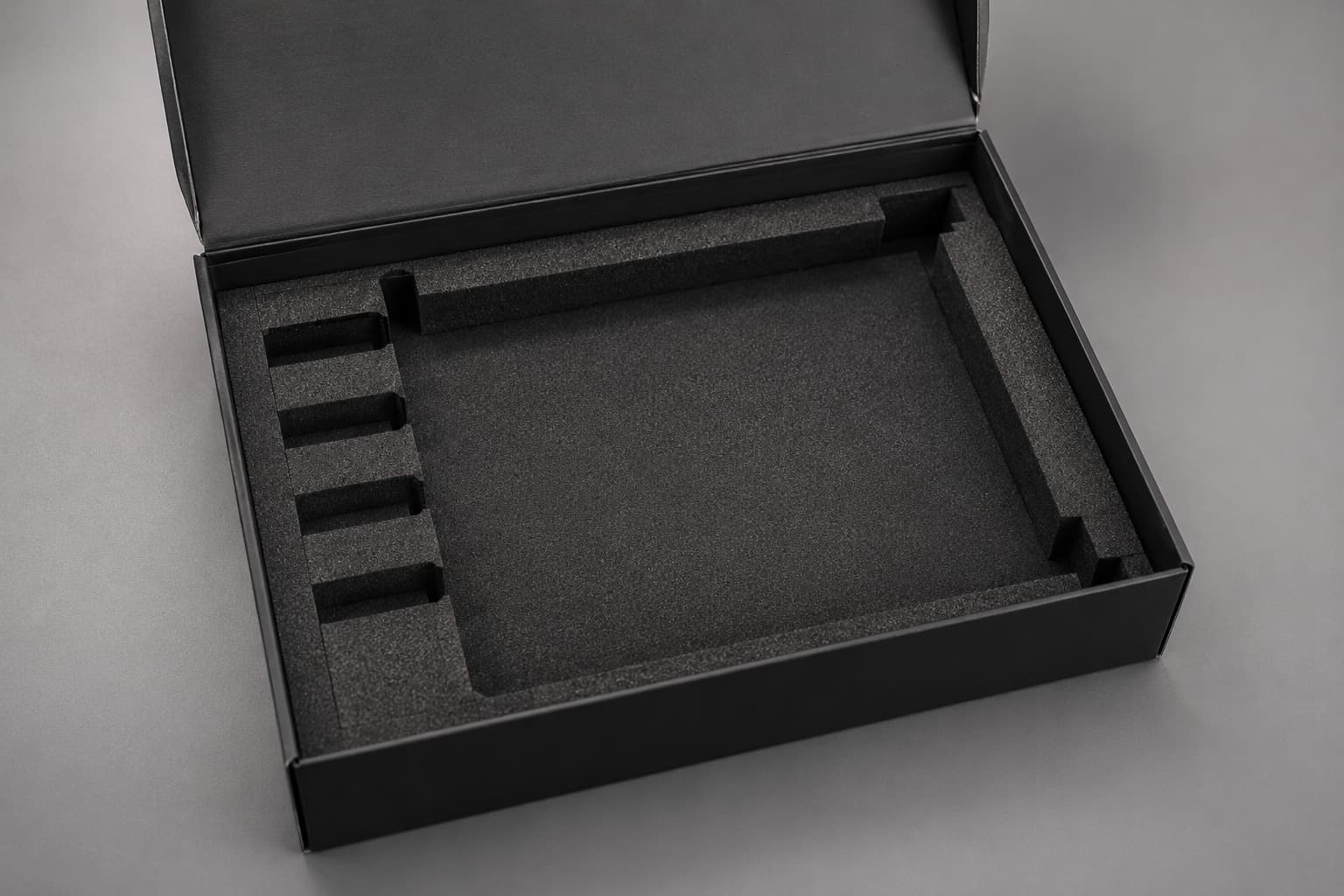 Custom black foam insert inside kraft packaging box for secure product protection